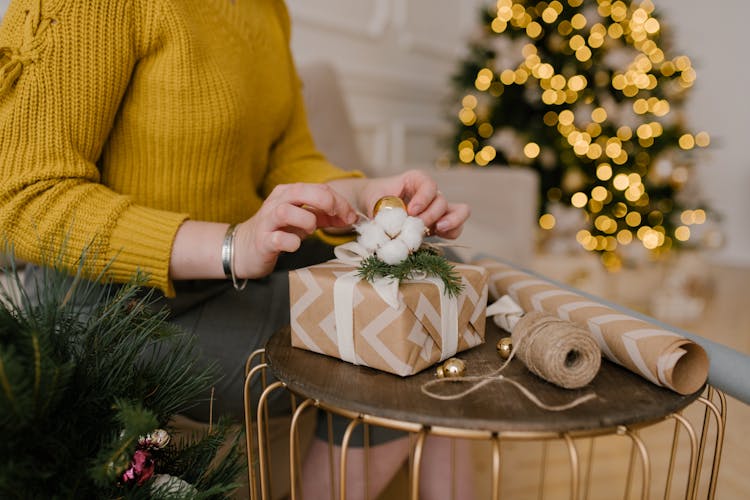 Close-Up Shot Of A Person Wrapping A Gift