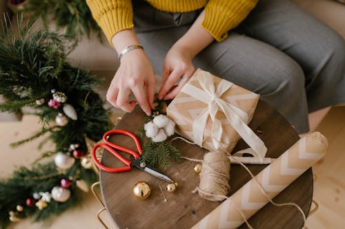 Close-Up Shot of a Person Wrapping a Gift