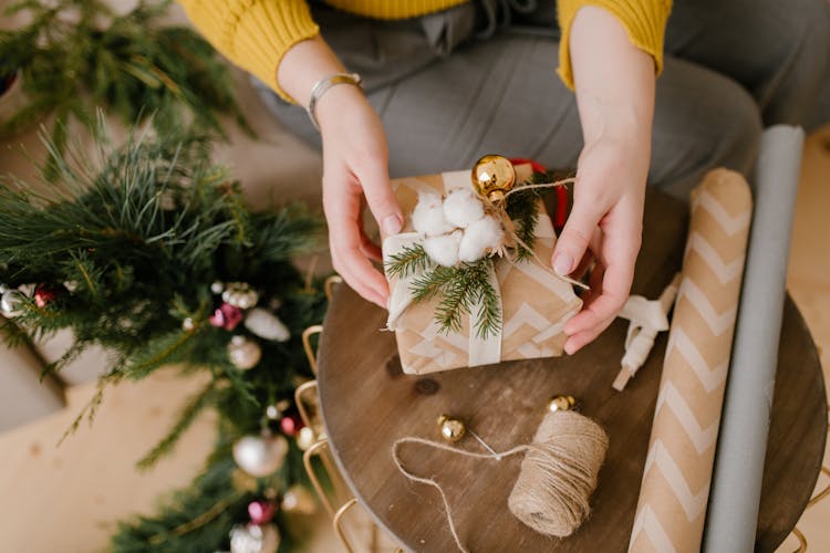 Close-Up Shot Of A Person Wrapping A Gift