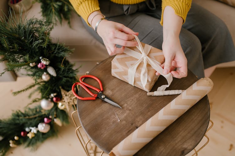 Close-Up Shot Of A Person Wrapping A Gift