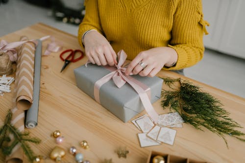 Close-Up Shot of a Person Wrapping a Gift