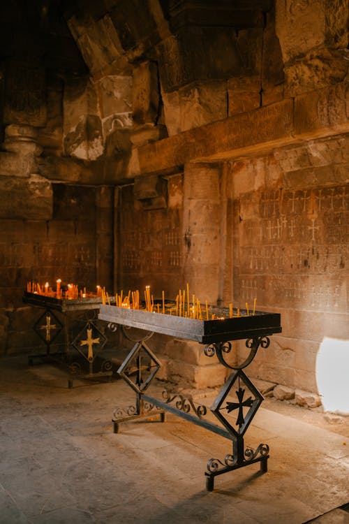 Burning candles in old palace with arched ceiling