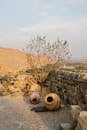 Clay jugs near stone wall of ancient building