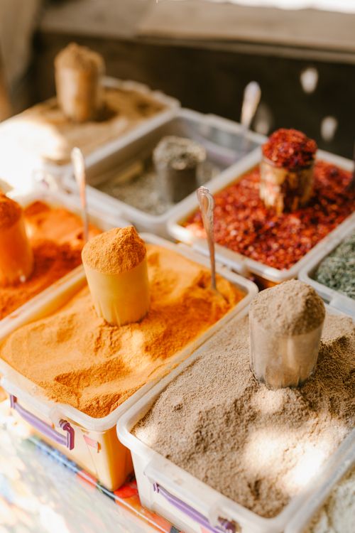 Free From above of assorted condiments and spices in plastic containers selling at bazaar Stock Photo