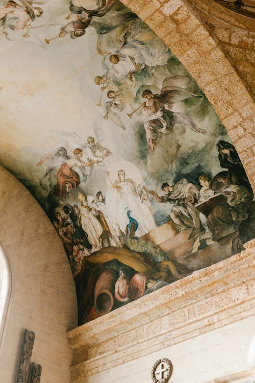 From below of aged round ceiling of stone building decorated with frescoes in National Pantheon of Dominican Republic
