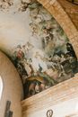 From below of aged round ceiling of stone building decorated with frescoes in National Pantheon of Dominican Republic