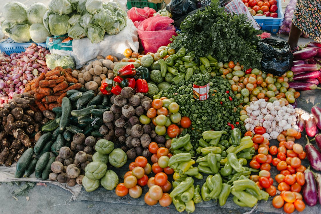 Free From above of various vegetables including pepper beets cabbage tomatoes greens potato zucchini and carrot at bazaar Stock Photo