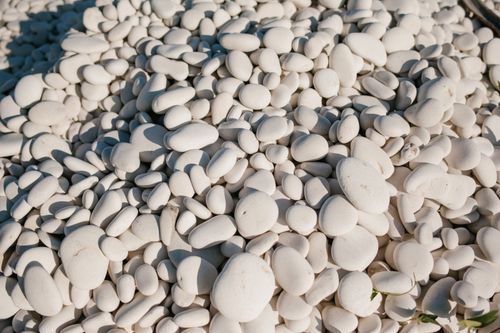 Free From above of white small smooth and round stones in pile at sunshine Stock Photo