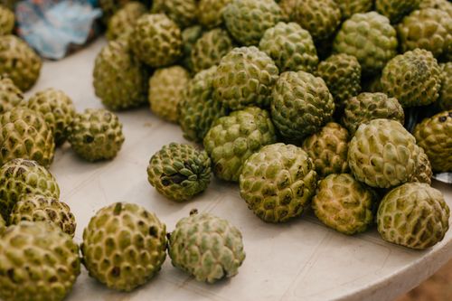 Free From above of stack of fresh ripe exotic globe artichokes placed on table in countryside Stock Photo