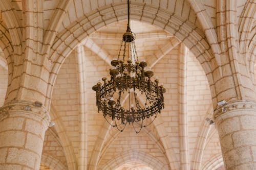 Old cathedral interior with ornamental chandelier on ceiling