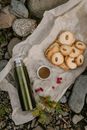 Cup of tea near crunchy biscuits and thermos on parchment