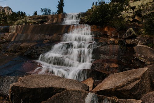 Clean waterfall flowing on rocky formation