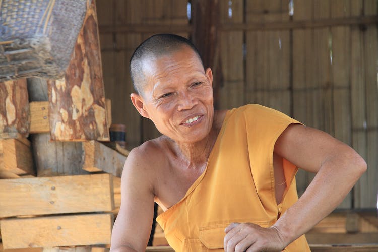 A Smiling Man Wearing Monk Robe