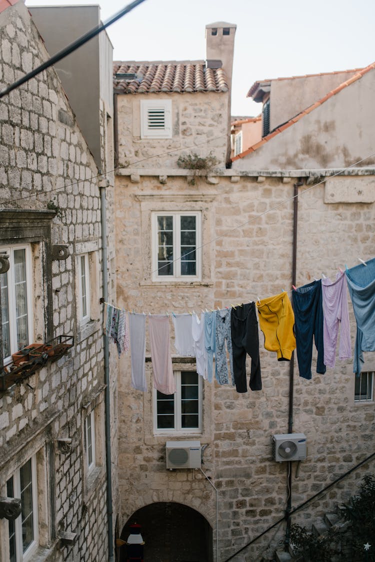 Clothesline Between Masonry Buildings In City