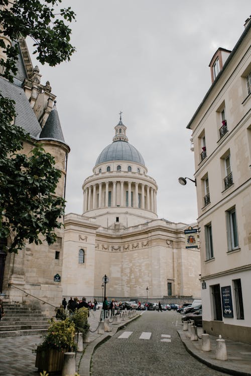 Free Landmark of Paris Pantheon aged monumental building built on territory of Abbey of Saint Genevieve with travelers walking around Stock Photo