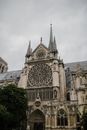 From below of aged stone Notre Dame de Paris church with ornamental facade with carved elements