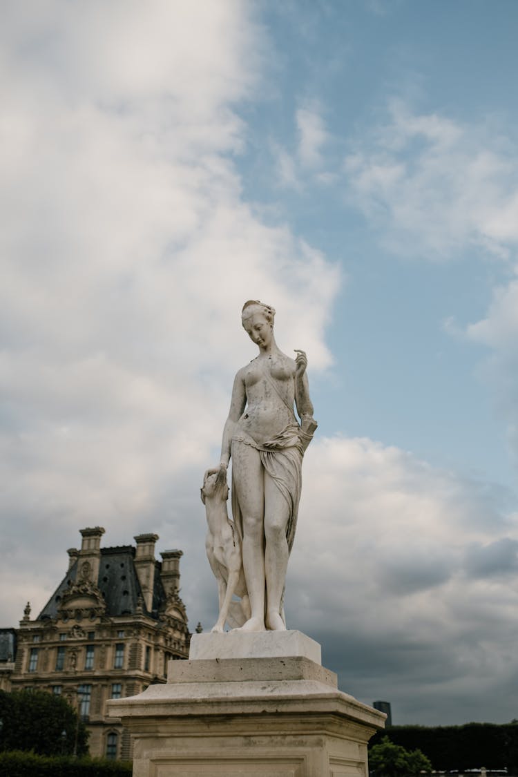 Old Marble Sculpture On Pedestal In City