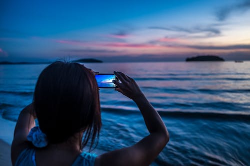 A Person Taking Picture of Sea Using a Smartphone