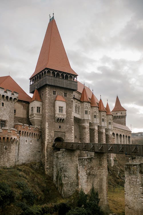 Free Gothic majestic castle under cloudy sky Stock Photo