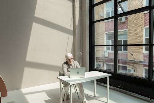 Busy male employee using netbook in spacious workplace