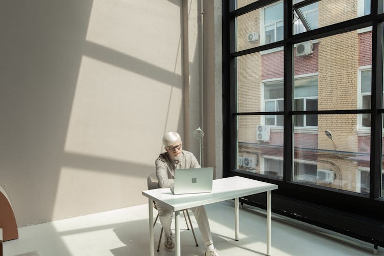 Busy Male Employee Using Netbook In Spacious Workplace