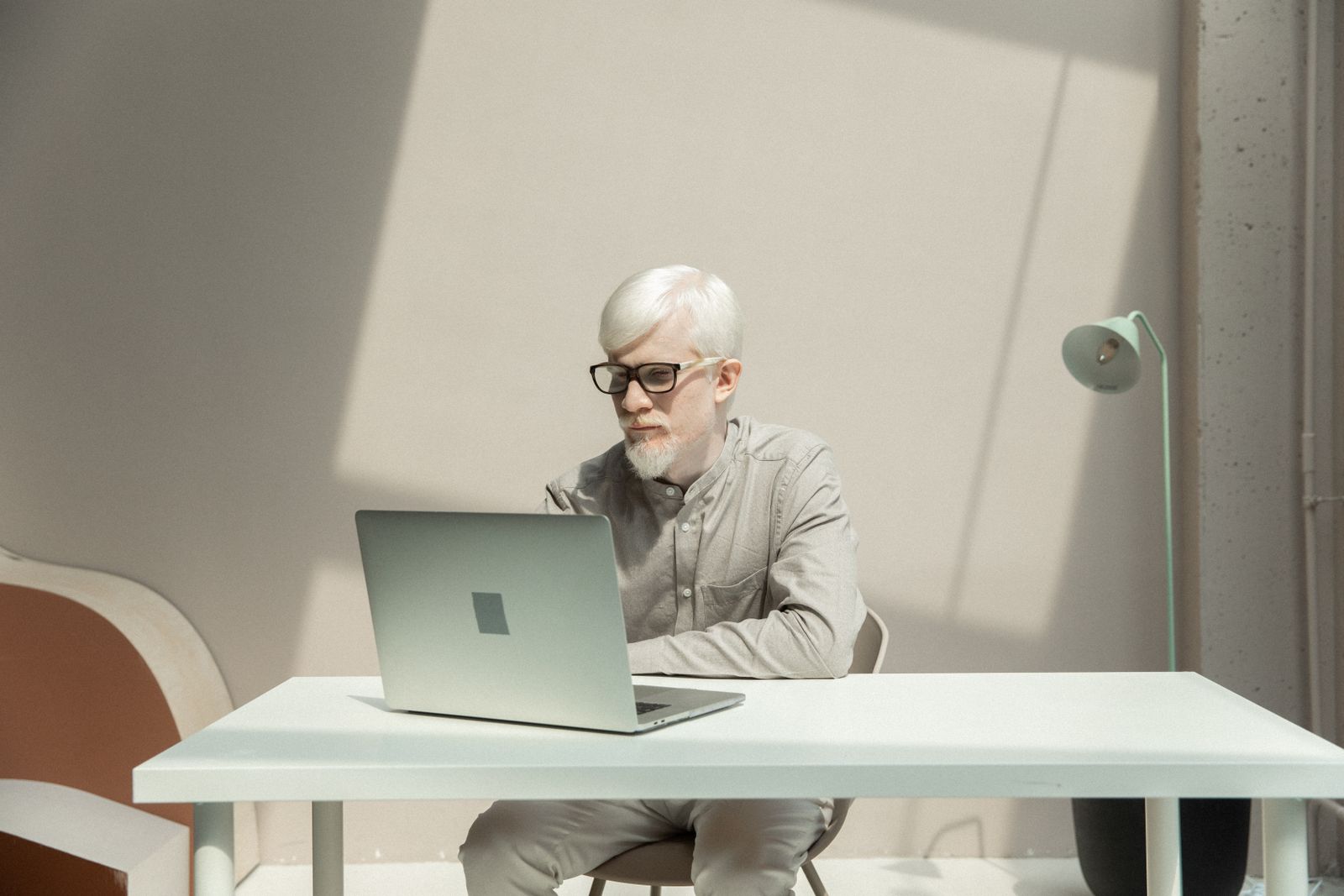 Founder working focused on a laptop in a minimalist modern office