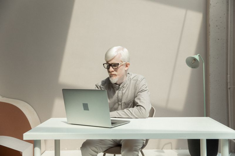 Founder working focused on a laptop in a minimalist modern office