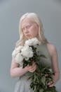 Albino woman with bouquet of flowers