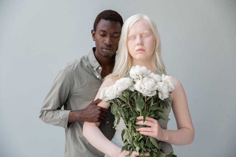 Albino And Black Couple With Flowers