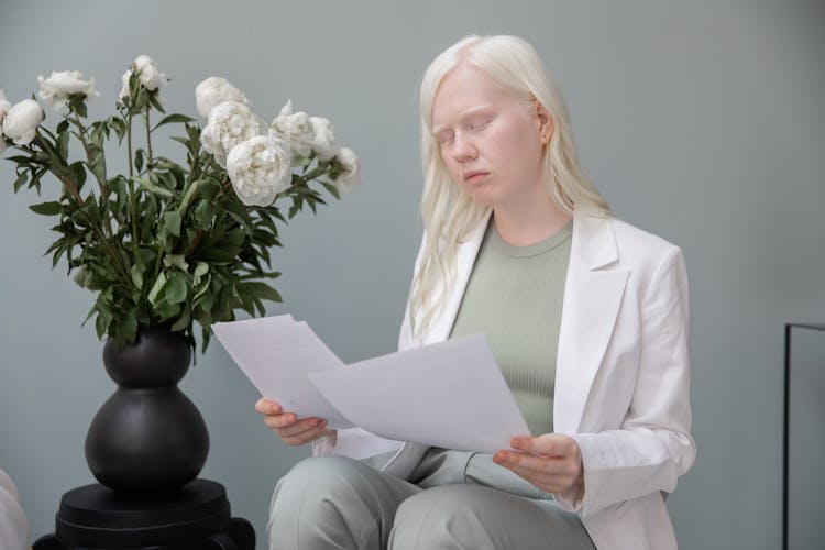 Albino Woman With Documents In Room