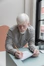 Busy albino man writing in document
