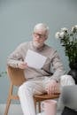 Serious albino man sitting with papers