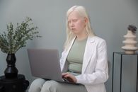 Busy albino woman with laptop