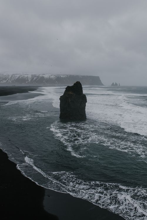 Free Captivating view of Reynisdrangar rock formations in Iceland's overcast seashore scenery. Stock Photo