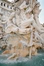 White marble Fountain of Four Rivers showing river god located in Rome on clear day