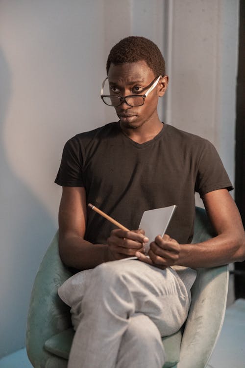 Serious black man with notebook
