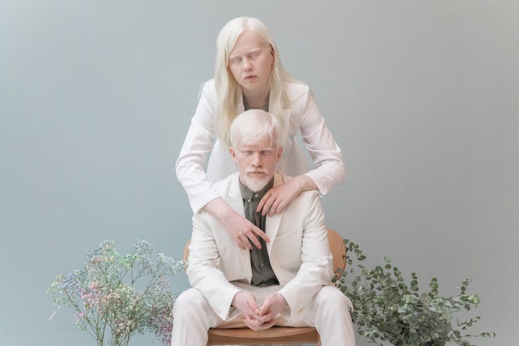 Albino Couple Hugging In Studio With Flowers