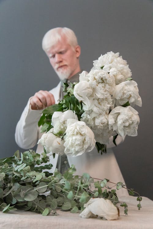 Man making bouquet of fresh flowers