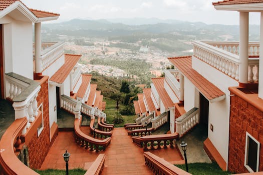 Elegant architecture with red-tiled roofs overlooking a scenic hillside town.