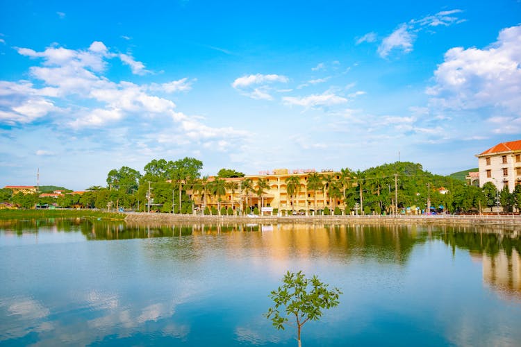 Hotel Building With Green Trees Near River