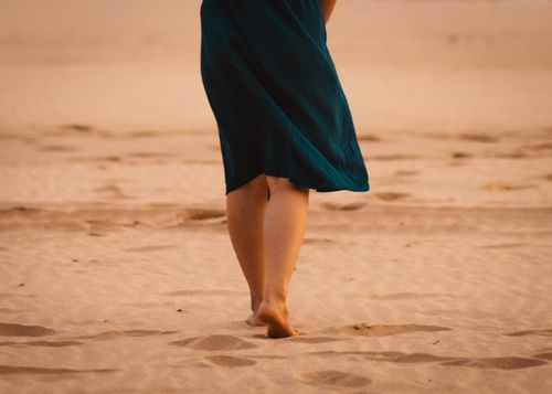 Free A person walks barefoot on a sandy beach in West Java, Indonesia, capturing tranquility and solitude. Stock Photo