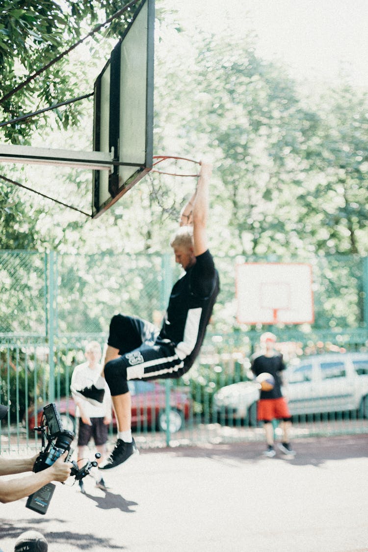 Man Dunking On A Basketball Court