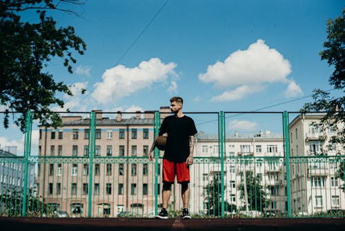 A Person Standing with a Ball