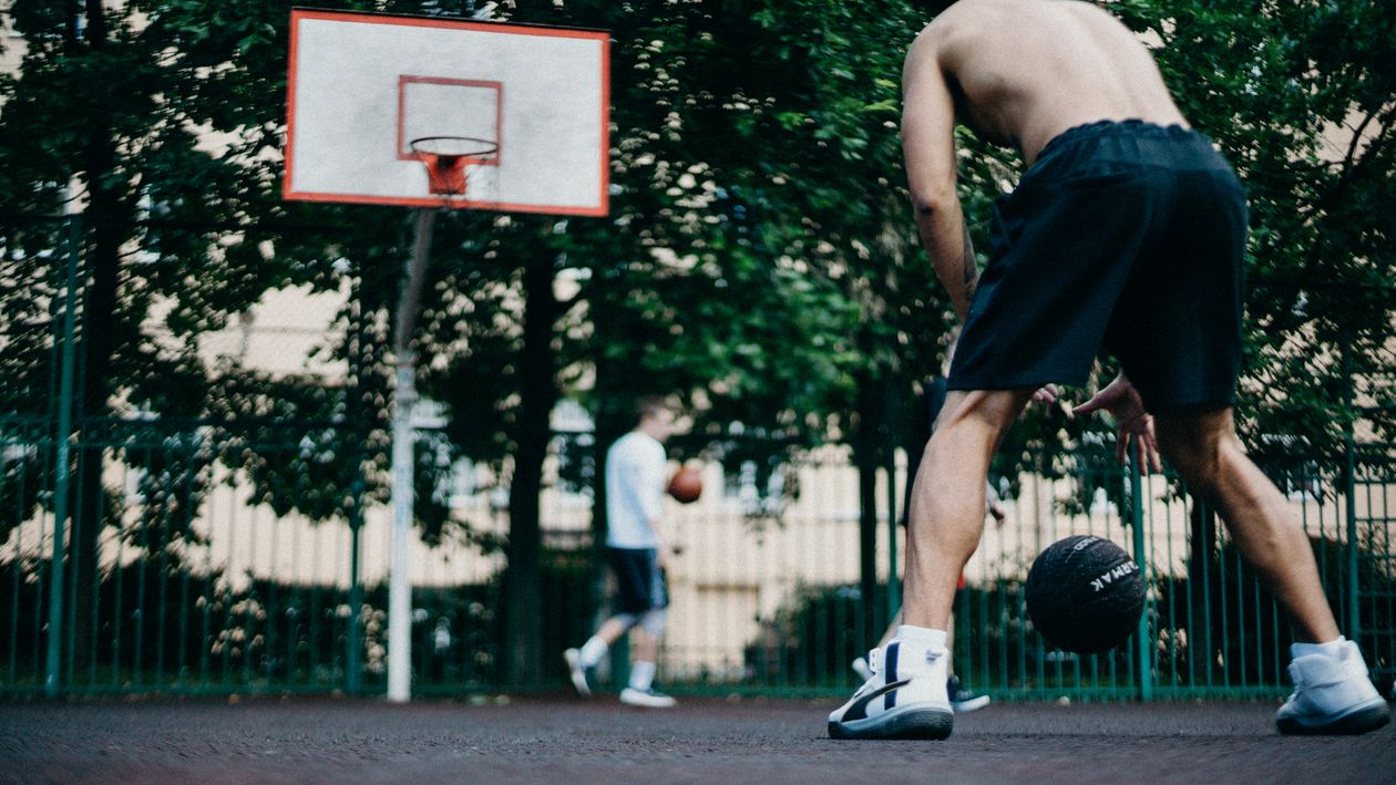 Basketball players competing on court