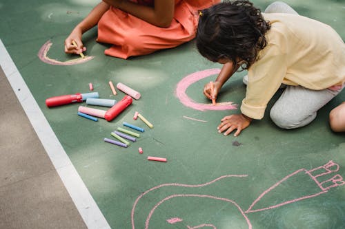 Free Children Drawing on Concrete with Chalk  Stock Photo