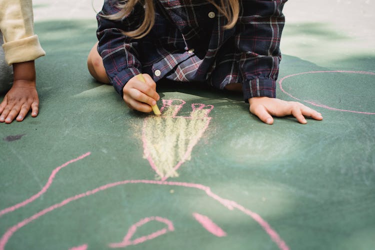 Children Drawing With Chalk On Concrete 