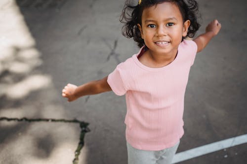 Portrait of Little Girl with Outstretched Arms 