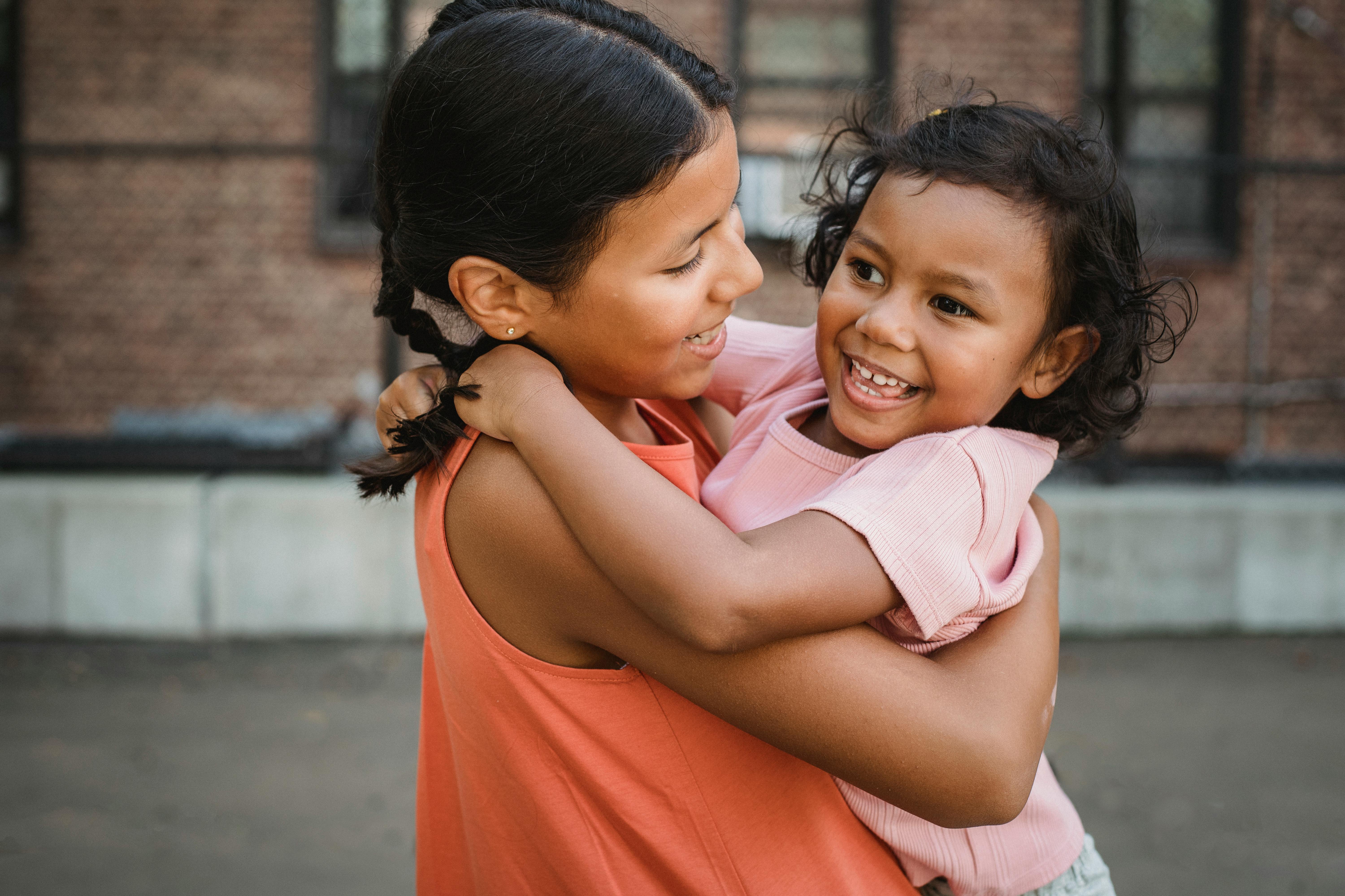A Girl Carrying a Child · Free Stock Photo