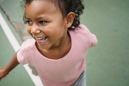 A Girl in Pink Shirt Smiling