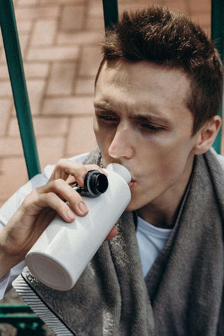 Man Drinking From White Tumbler